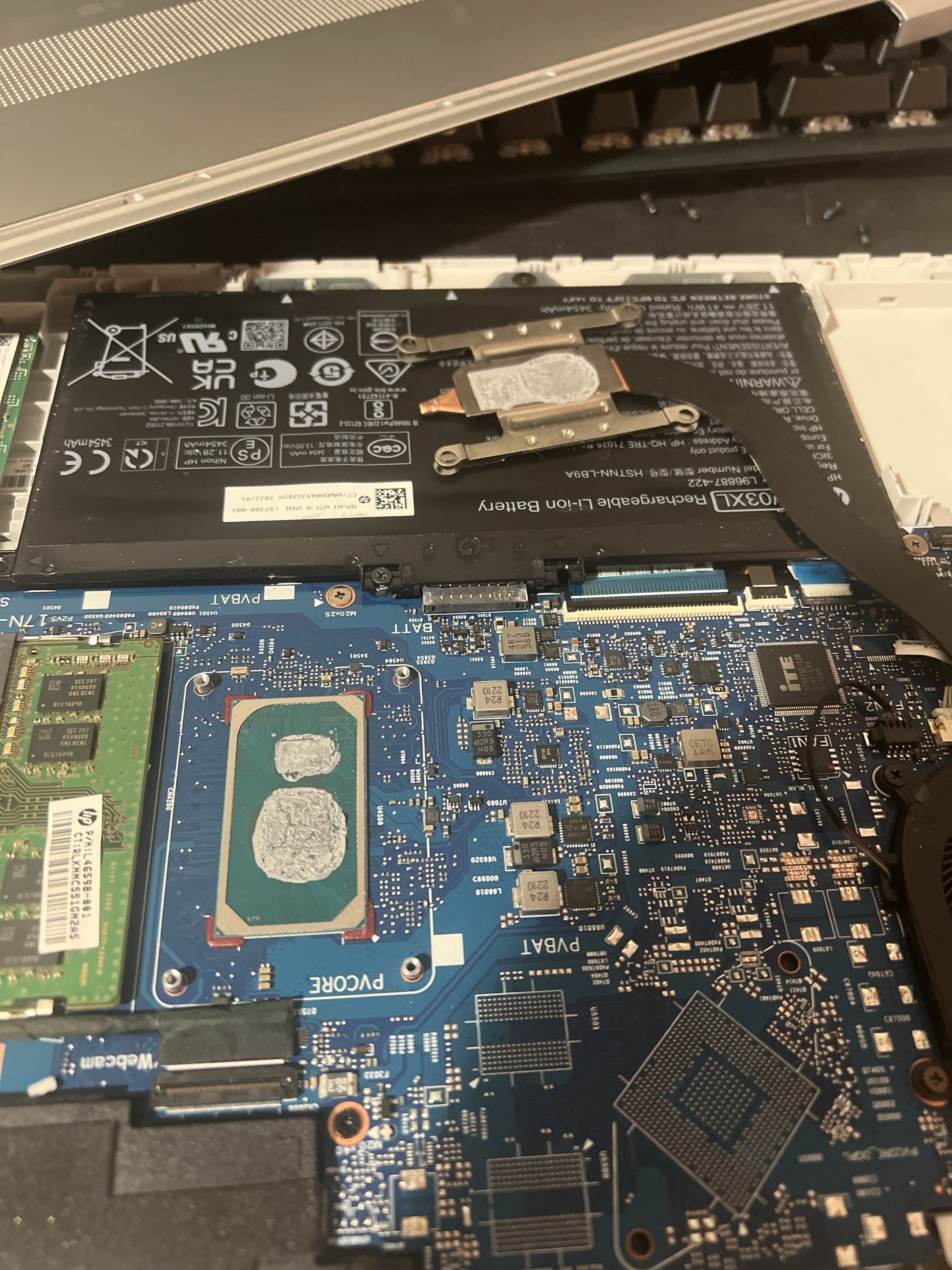 Open laptop with exposed CPU and GPU during thermal maintenance